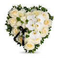 Heart-shaped arrangement of white flowers with green leaves on a white background