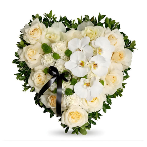Heart-shaped arrangement of white flowers with green leaves on a white background