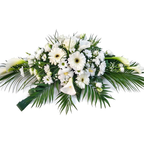 Floral arrangement with white flowers and green leaves on a white background