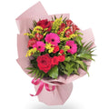 Bouquet of flowers wrapped in pink paper with a pink ribbon on a white background
