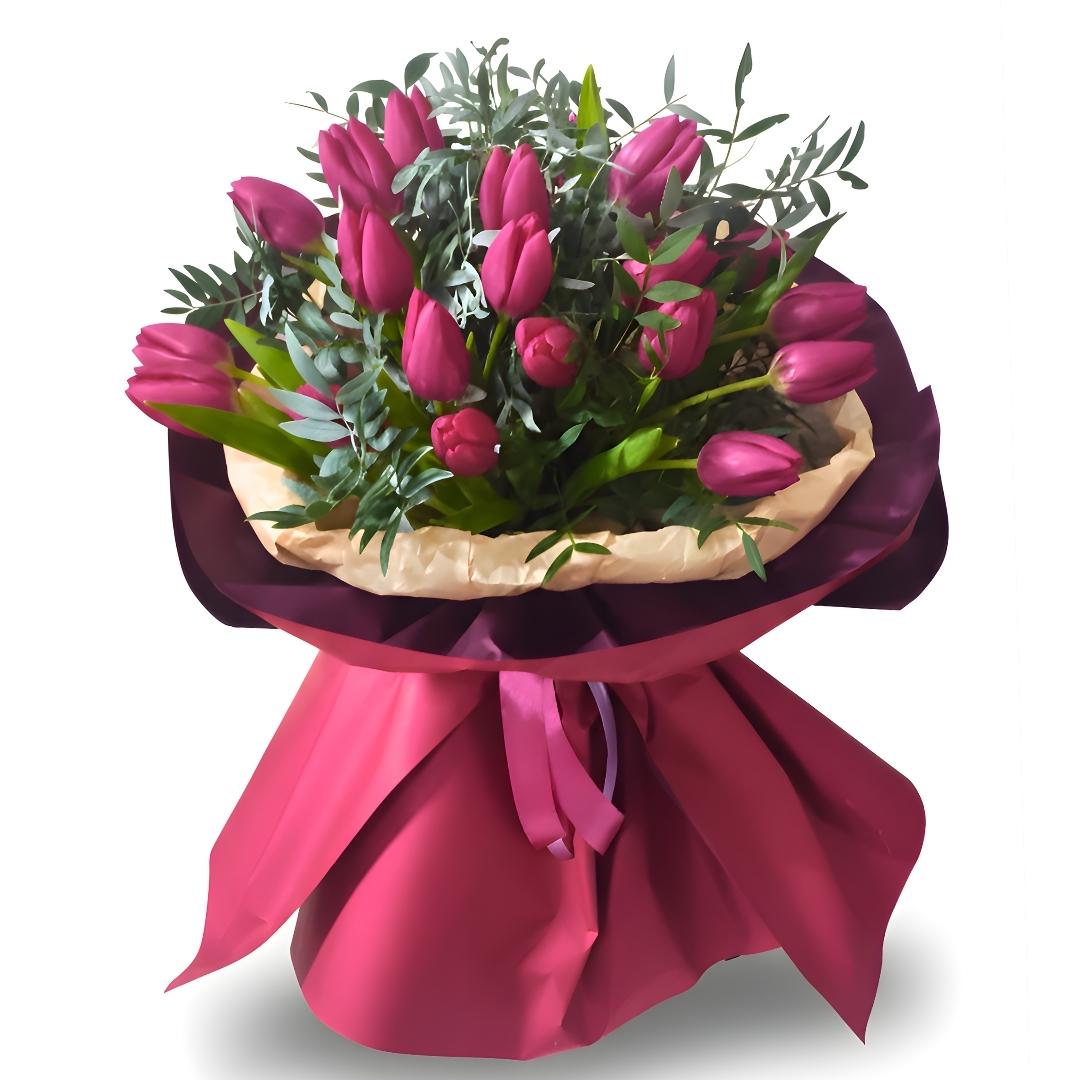 Bouquet of pink tulips with greenery wrapped in pink paper and ribbon on a white background