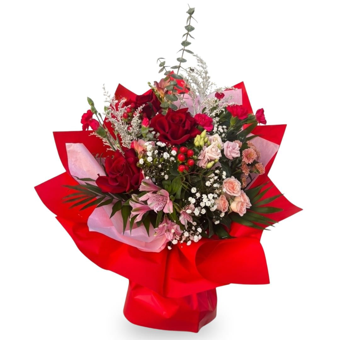 Bouquet of flowers wrapped in red paper on a white background