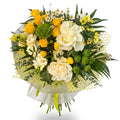 Bouquet of yellow and white flowers with greenery on a white background
