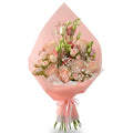 Bouquet of flowers wrapped in pink paper on a white background