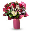 Bouquet of flowers with pink ribbon on a white background