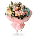 Bouquet of flowers wrapped in pink paper on a white background
