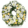 Floral wreath with white, yellow, and green flowers on a white background