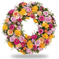 Colorful floral wreath with pink, yellow, and orange flowers on a white background