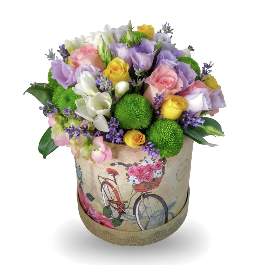 Colorful bouquet of flowers in a decorative box with a bicycle design on a white background