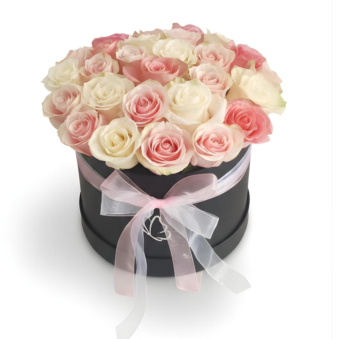 Black box with pink and white roses and a bow on a white background
